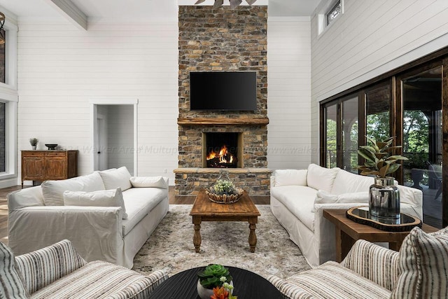 living room with wood walls, wood-type flooring, and a fireplace