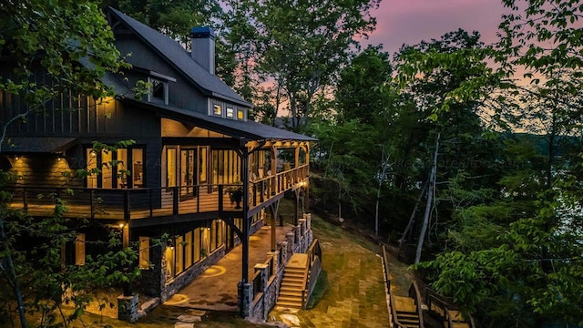 view of back house at dusk