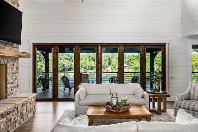 living room featuring hardwood / wood-style flooring, a wealth of natural light, and wood walls