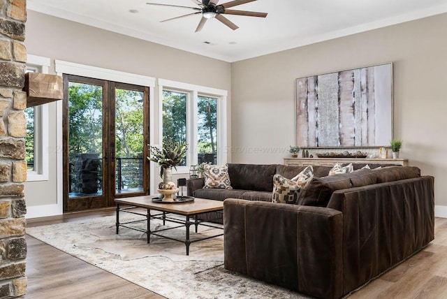 living room with ceiling fan, light hardwood / wood-style floors, and french doors