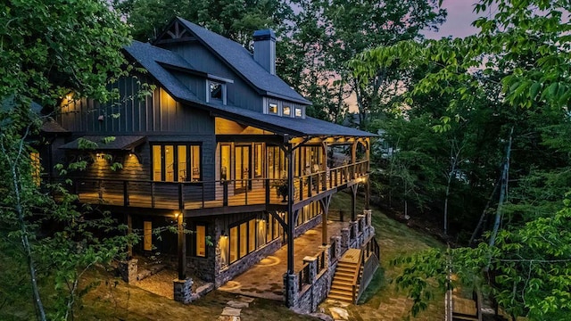 back house at dusk with a deck