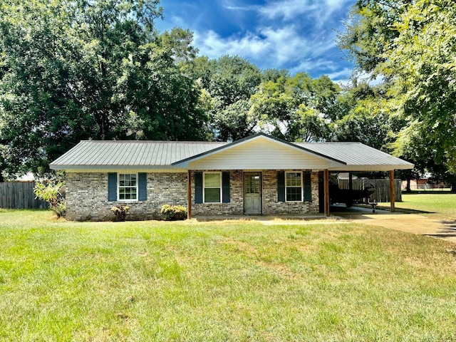 ranch-style house featuring a carport and a front yard