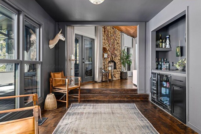 interior space with dark hardwood / wood-style flooring and beverage cooler