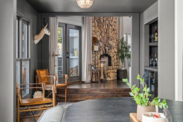 living area featuring a fireplace, dark hardwood / wood-style flooring, and wine cooler