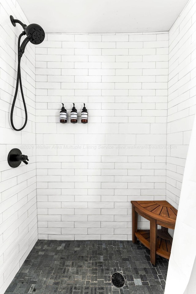 bathroom with a tile shower