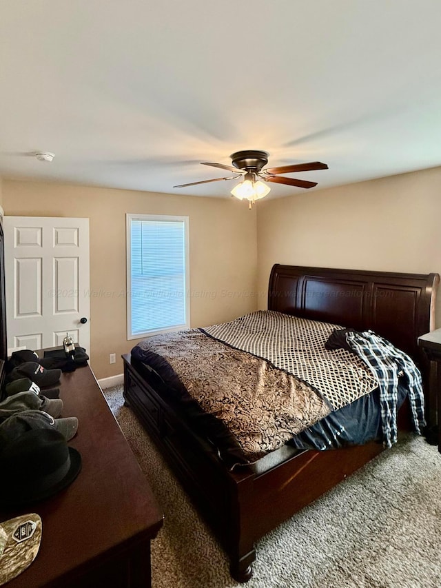 bedroom featuring baseboards, ceiling fan, and carpet flooring