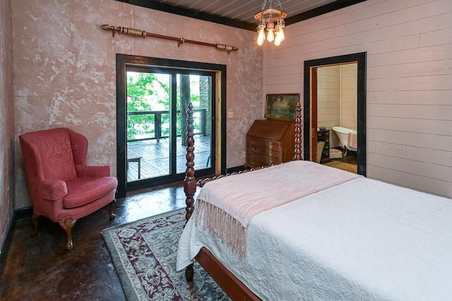 bedroom featuring connected bathroom, an inviting chandelier, access to exterior, wood walls, and concrete flooring