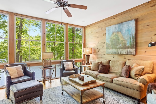 sunroom / solarium featuring ceiling fan