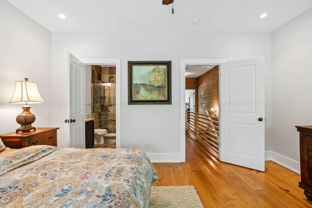 bedroom with ensuite bathroom and light hardwood / wood-style flooring