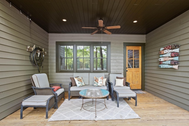 sunroom with ceiling fan and wooden ceiling