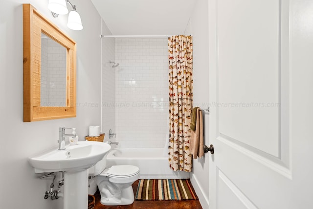 bathroom with shower / tub combo and toilet