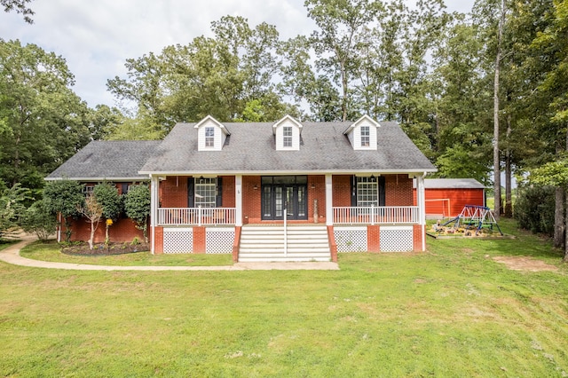 new england style home featuring covered porch and a front lawn