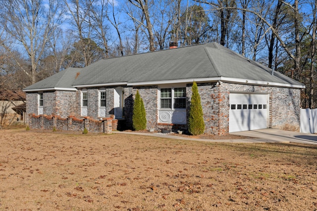 view of front of home featuring a garage and a front lawn