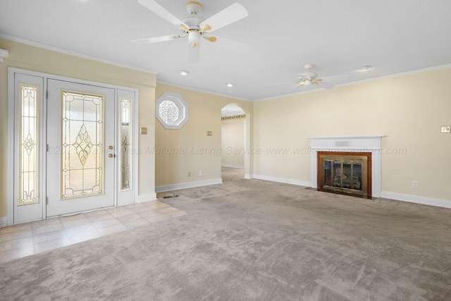 unfurnished living room featuring ceiling fan, crown molding, and light carpet