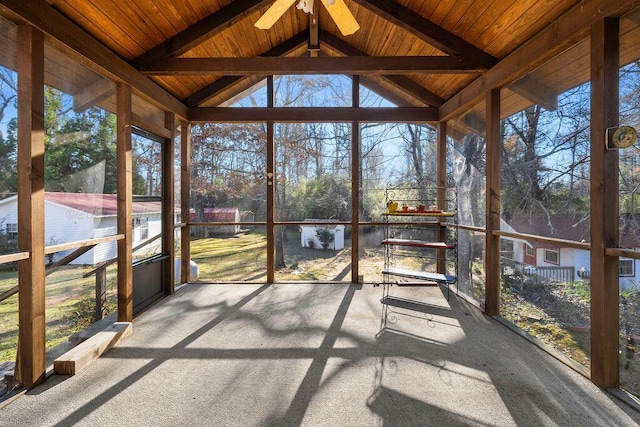 unfurnished sunroom with vaulted ceiling with beams, ceiling fan, and wood ceiling