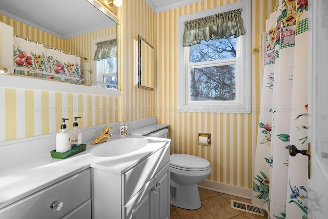 bathroom featuring tile patterned flooring, vanity, toilet, and crown molding