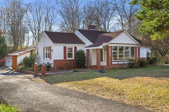 view of front of house with a front yard and a garage