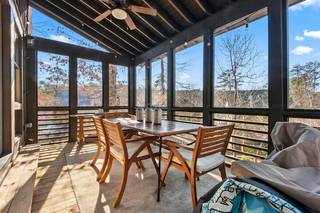 sunroom featuring ceiling fan and lofted ceiling with beams