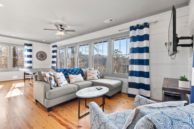 living room featuring ceiling fan and hardwood / wood-style flooring