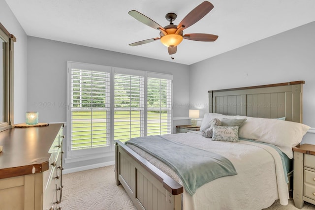 bedroom featuring light carpet and ceiling fan