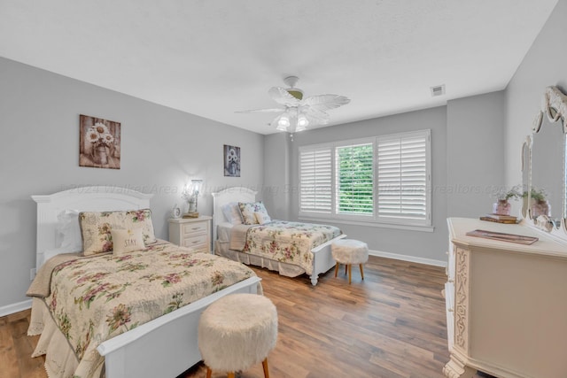 bedroom with ceiling fan and wood-type flooring