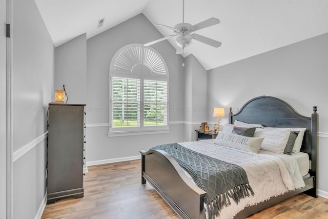 bedroom featuring hardwood / wood-style floors, ceiling fan, and lofted ceiling