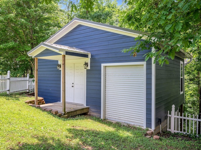 view of outdoor structure featuring a lawn and a garage