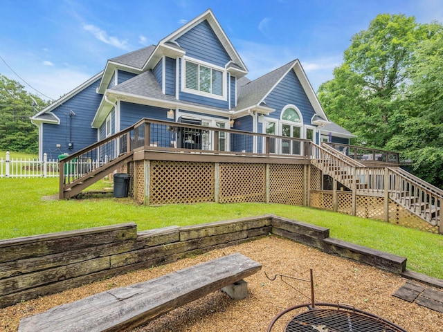 back of property featuring a lawn and a wooden deck