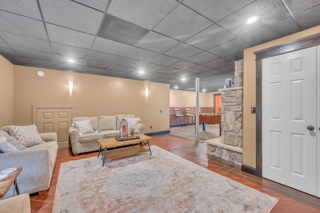 living room with hardwood / wood-style flooring and a drop ceiling