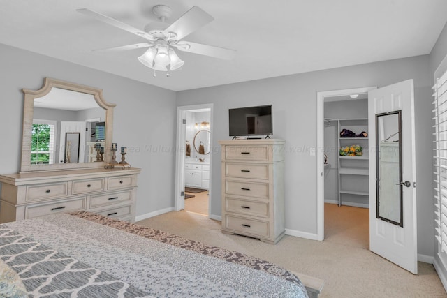 carpeted bedroom with a walk in closet, ensuite bathroom, a closet, and ceiling fan