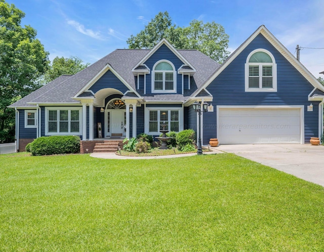 craftsman-style home featuring a garage and a front lawn