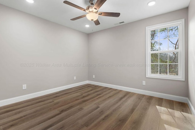 unfurnished room featuring recessed lighting, dark wood-type flooring, baseboards, a ceiling fan, and visible vents