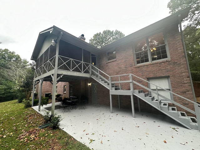 back of house with a sunroom and a patio area