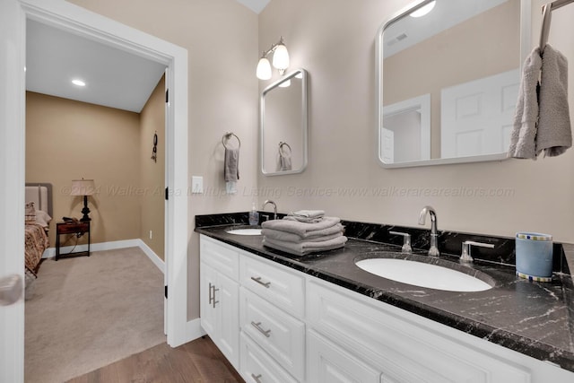 bathroom with vanity and hardwood / wood-style flooring