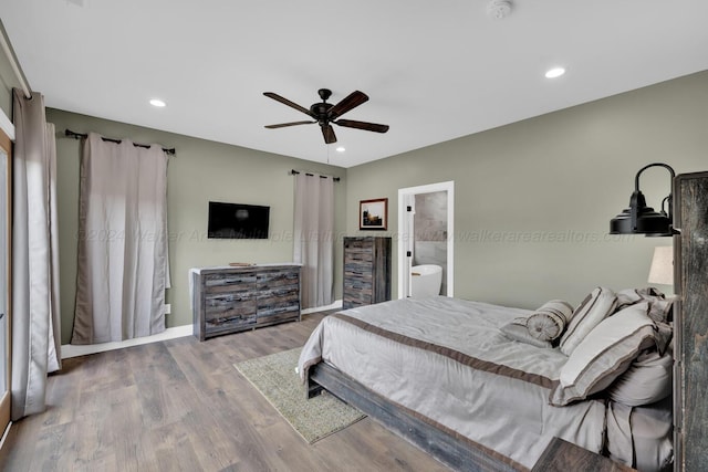 bedroom with ensuite bath, ceiling fan, and wood-type flooring