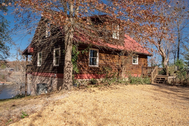 view of side of property with a wooden deck