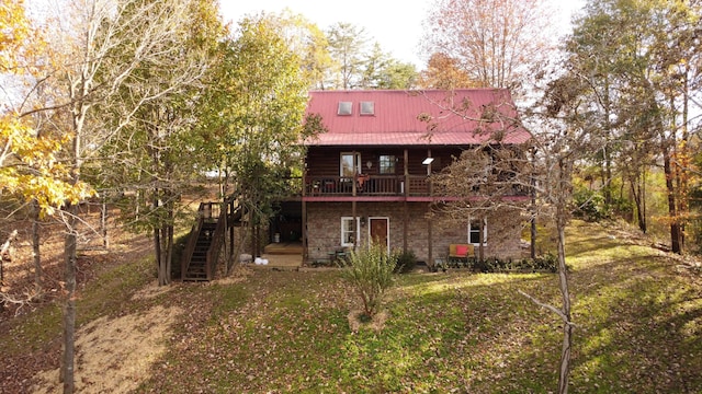 rear view of house featuring a yard and a deck