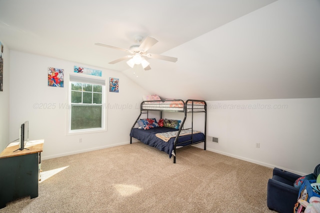 carpeted bedroom with lofted ceiling, baseboards, visible vents, and ceiling fan