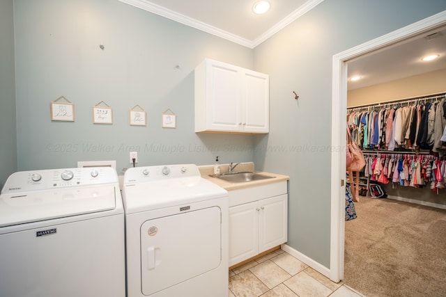 laundry room featuring washer and clothes dryer, a sink, cabinet space, crown molding, and light colored carpet