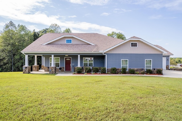 craftsman-style house with stone siding, roof with shingles, covered porch, and a front yard