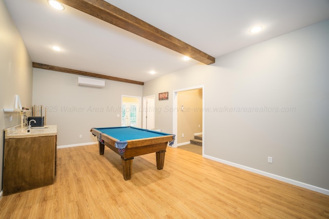 rec room featuring baseboards, a wall mounted air conditioner, light wood-type flooring, beam ceiling, and recessed lighting