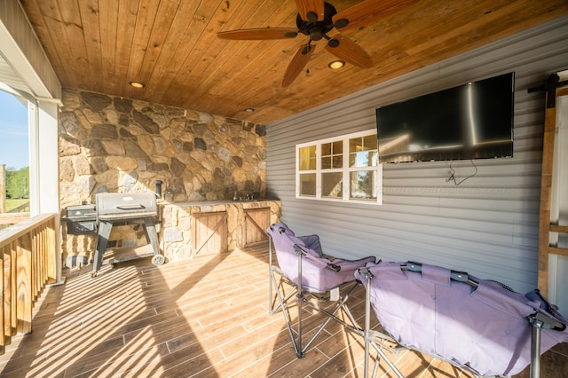 wooden deck with a grill and ceiling fan