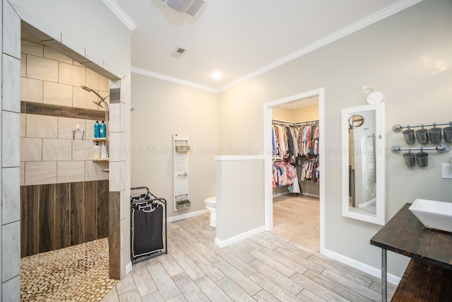 full bathroom with ornamental molding, toilet, walk in shower, and wood finished floors