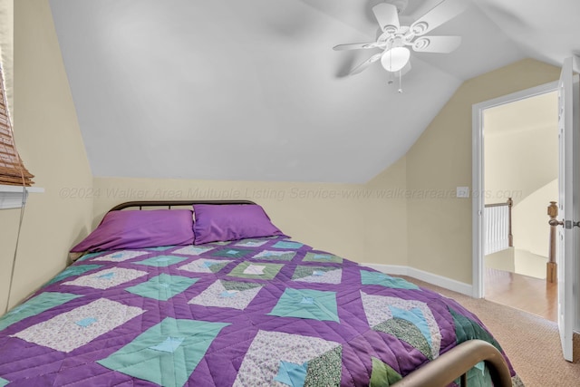 carpeted bedroom with ceiling fan and lofted ceiling