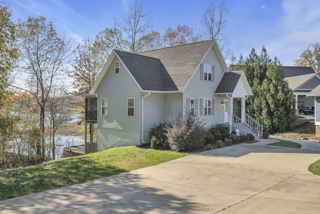 view of front of property with a water view and a front yard