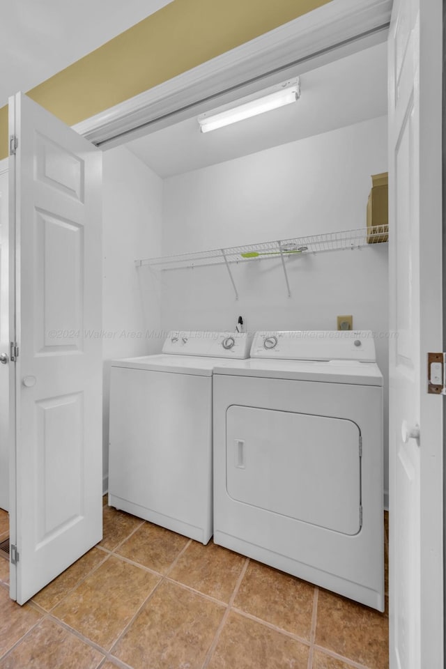 laundry area featuring independent washer and dryer and light tile patterned flooring