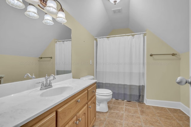 bathroom featuring tile patterned floors, vanity, toilet, and lofted ceiling