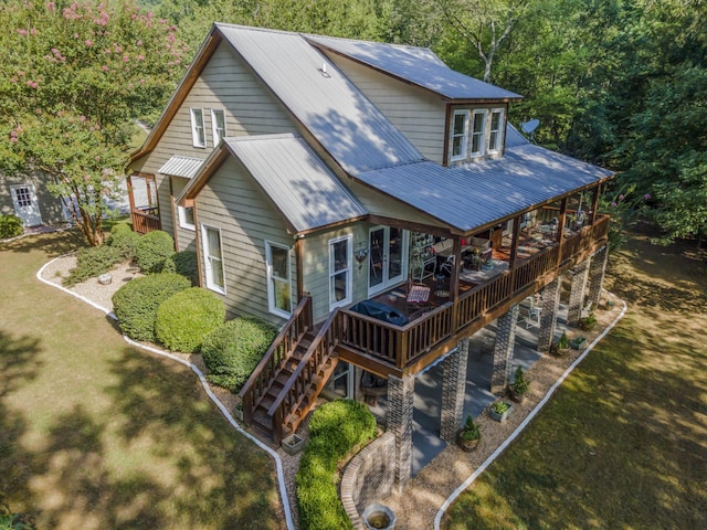 back of house with a wooden deck and a lawn