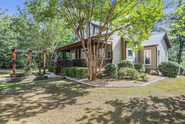 view of side of home featuring a yard and a porch