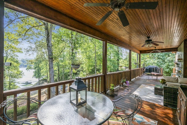 deck with ceiling fan, an outdoor hangout area, and grilling area